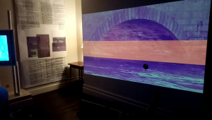 A photograph of the artwork Assembly by Shane Finan, showing one of the projected videos in the Memory Room